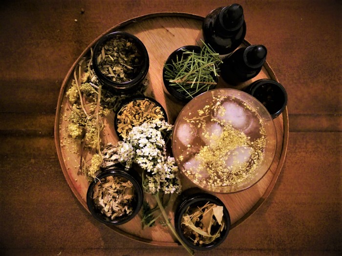 Jars of foraged ingredients with dried flowers and cocktail
